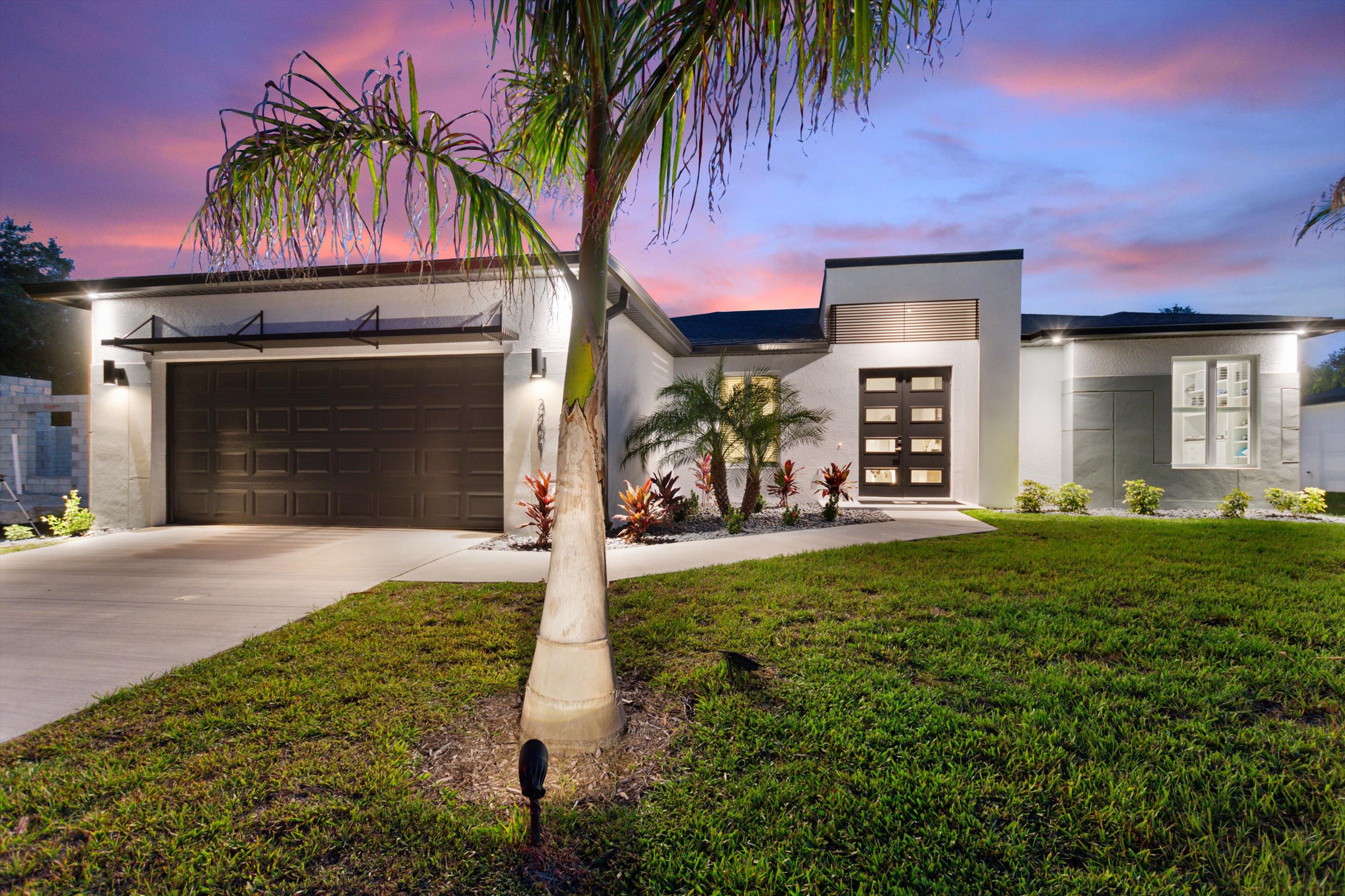 Brock Homes modern home illuminated at dusk